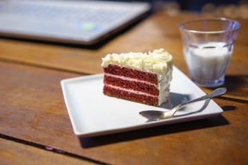 cake chocolate on wood table work with laptop notebook computer