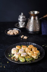 Maamoul or mamoul - arabic cookies stuffed dates or phistachio with icing cugar on dark background. Selective focus