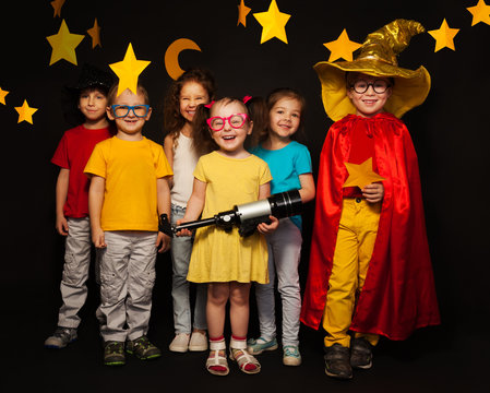 Six kids in stargazers costumes with telescope