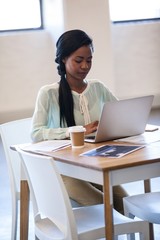 Obraz na płótnie Canvas Portrait of businesswoman typing on her laptop