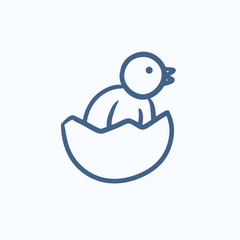 Chick peeking out of egg shell sketch icon.