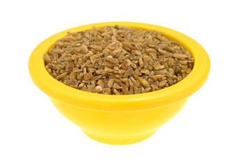 Bowl of cracked freekeh isolated on a white background side view.