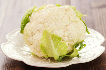 cauliflower on white dish on brown background