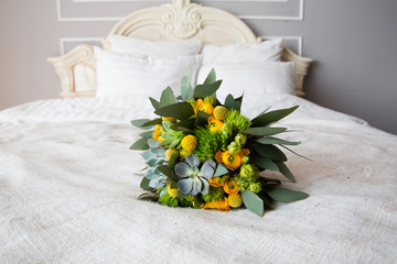 Bridal bouquet on the bed 