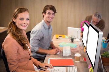 Smiling business people sitting in office