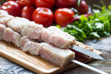 Raw pork meat, making kebab. Skewers ready for grilling
