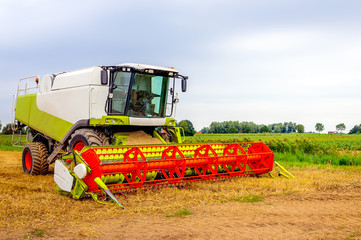 Closeup of a colorful combine parked after finishing the work