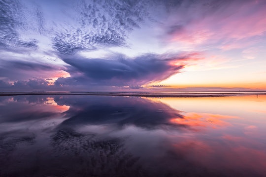 Colorful dramatic sunset sea with reflection