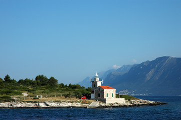 Fototapeta na wymiar Seascape and lighthouse on the coast near Hvar island, Croatia