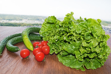 Vegetables. Tomato, cucumber, green salad wooden