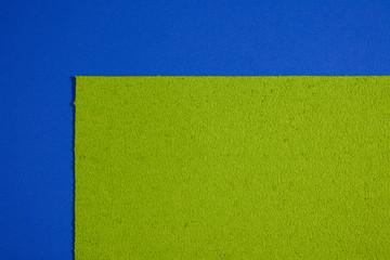 Eva foam ethylene vinyl acetate sponge plush apple green surface on blue smooth background