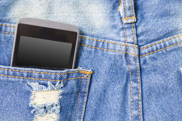 Mobile phone in the back pocket of blue jeans with copyspace mac