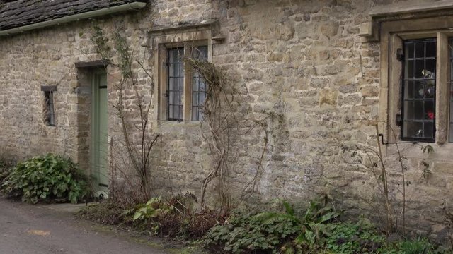 Historical cottages Bibury Cotswolds England scenic beautiful. Historical village homes business. Cotswolds, Area of Outstanding Natural Beauty (AONB) rolling hills and rivers. Destination for tourism