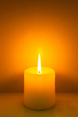 closeup to burning candles in darkness