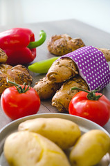 Pepper, potato, kaiser bun and baguette on wood table. Vegetaria