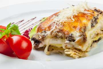 Portion of tasty lasagna, isolated on white