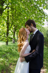 Fototapeta premium Young couple kissing outdoors