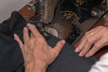 Tailor using industrial sewing machine
