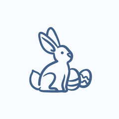 Easter bunny with eggs sketch icon.
