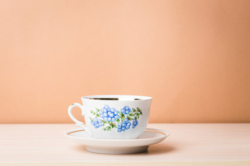 Cup of black tea in a china cup and saucer