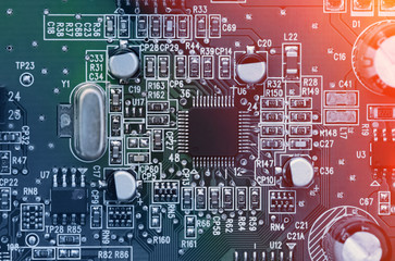 Printed computer circuit board with electronic components. Computer and networking communication technology concept. Toned image.