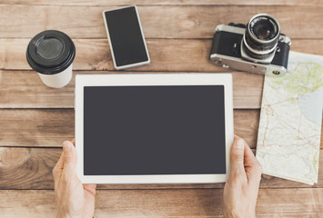 Young man planning vacation trip with digital tablet