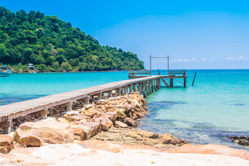Wooden bridge on the clear water in the tropical island