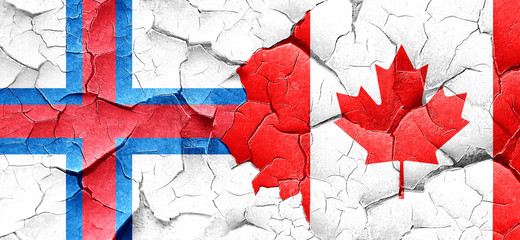 faroe islands flag with Canada flag on a grunge cracked wall