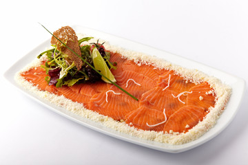 Fresh salmon with lemon on the white plate