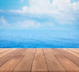 Wood table top on blue sea and sky background


