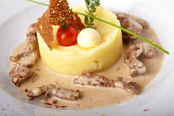 Baked meat with mashed potatoes on the white plate