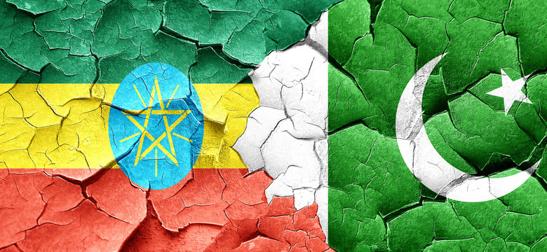 Ethiopia flag with Pakistan flag on a grunge cracked wall