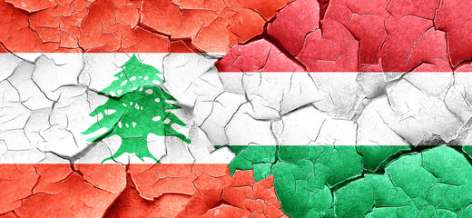 Lebanon flag with Hungary flag on a grunge cracked wall