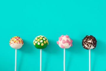 Colorful cake pops on blue background

