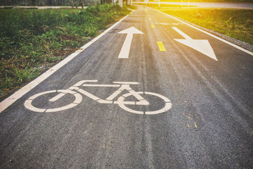 Obraz premium Bike lane sign on the road in city way ,warm vintage tone