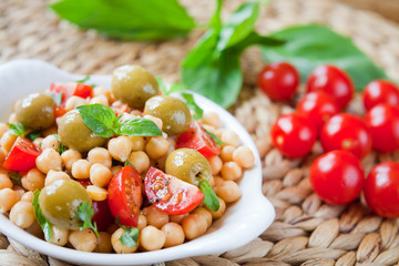 Mediterranean salad board - cherry tomatoes, green olives, chickpea.
