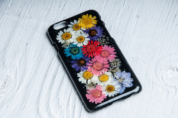 Vintage floral pattern protective case for smart phone on white wooden background