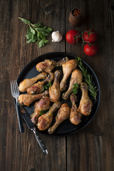 Fried chicken legs with spices, rosemary and mint