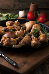 Fried chicken legs with spices, rosemary and mint