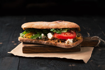 Sandwich with meat, pesto and goat cheese
