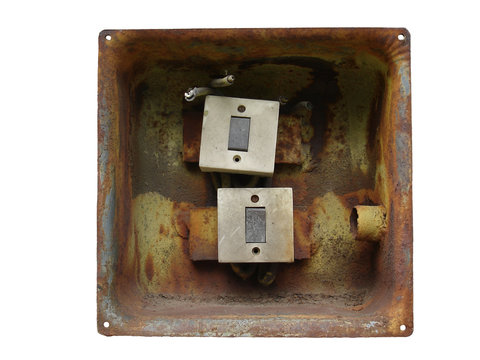 Two electrical switch in the rusty metal box isolated on white