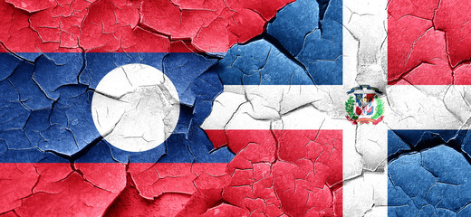 Laos flag with Dominican Republic flag on a grunge cracked wall
