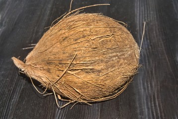 Coconut against black wood