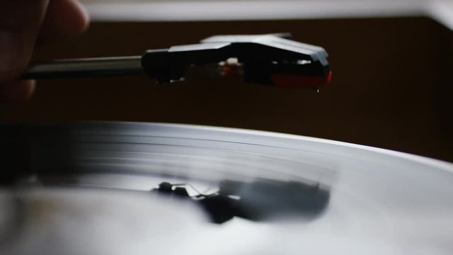4K Record being placed on a record player and spinning as needle comes down