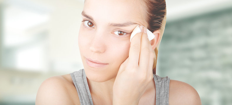Ragazza si strucca viso con dischetto cotone