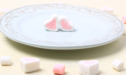 Fototapeta na wymiar pair of heart marshmallow on a plate valentines day love romantic background