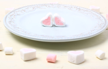 Obraz na płótnie Canvas pair of heart marshmallow on a plate valentines day love romantic background