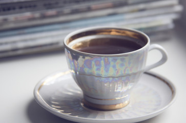 morning cup of coffe (espresso) and ream of newspapers
