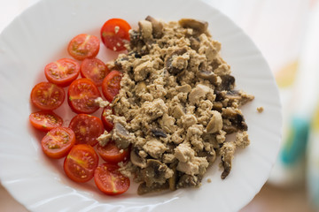 Healthy vegan omelette cooked for breakfast made of tofu, mushrooms and tomatoes