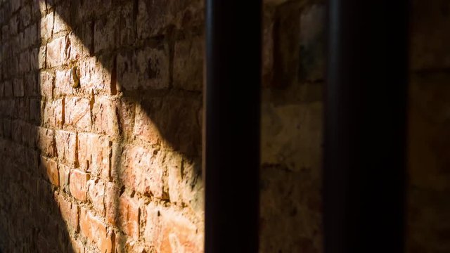Time-lapse of sun rays moving over an rustic brick wall in an office space